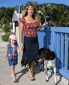 mother and daughter walking the dog